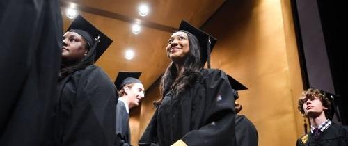 students in cap and gown at graduation